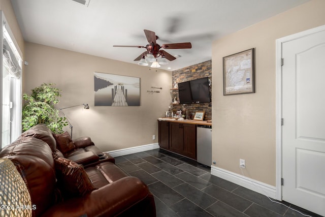 5612 S 21st Pl, Phoenix, AZ 85040 - bar area featuring fridge, ceiling fan, baseboards, and dark tile patterned flooring