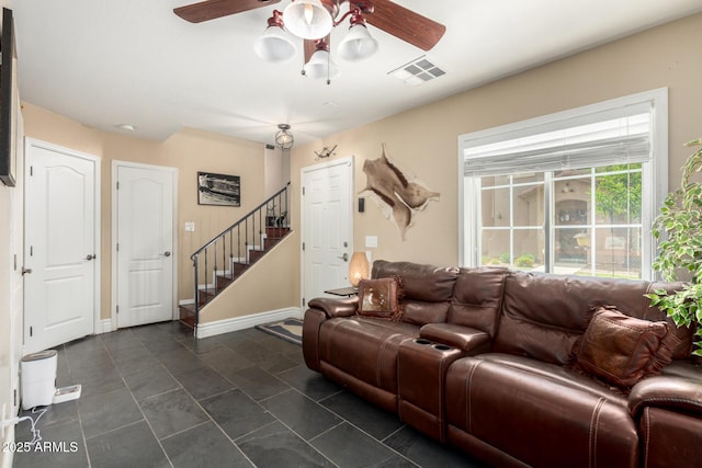 5612 S 21st Pl, Phoenix, AZ 85040 - living area with a ceiling fan, stairs, dark tile patterned floors, and baseboards