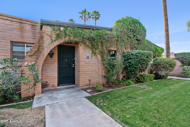 entrance to property featuring a yard