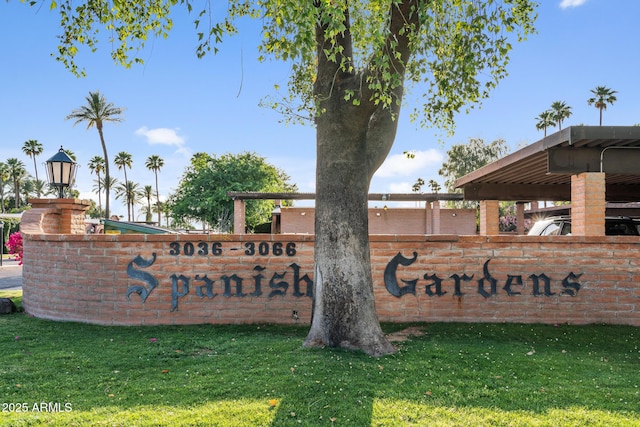 community / neighborhood sign with a yard