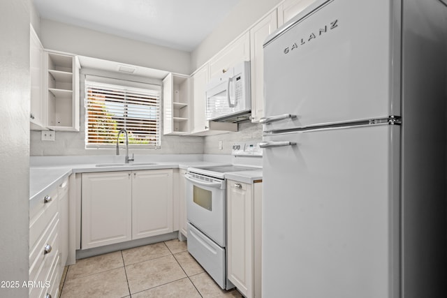 kitchen with a sink, open shelves, white cabinetry, white appliances, and light tile patterned floors