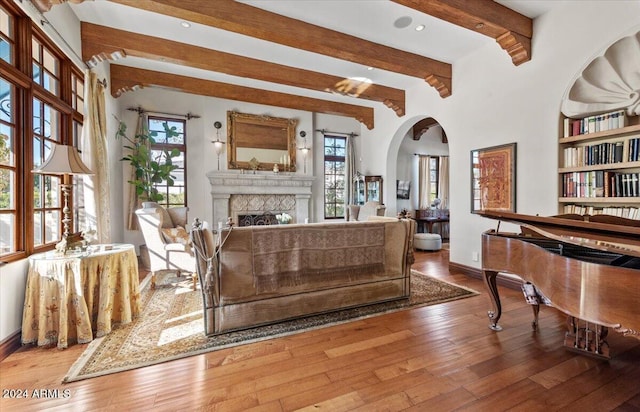 sitting room with beam ceiling and hardwood / wood-style floors