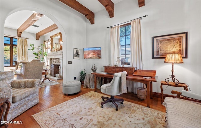 sitting room featuring beamed ceiling and light wood-type flooring