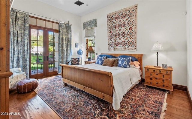 bedroom with hardwood / wood-style floors, access to outside, and french doors