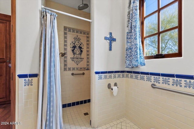 bathroom featuring a shower with curtain and tile walls