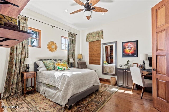 bedroom with light hardwood / wood-style floors and ceiling fan