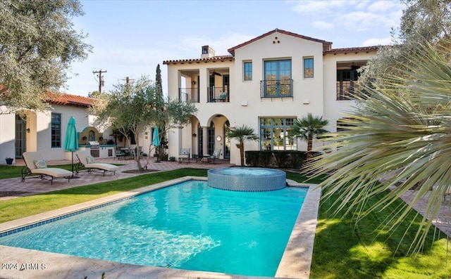 back of house with a patio area and a balcony