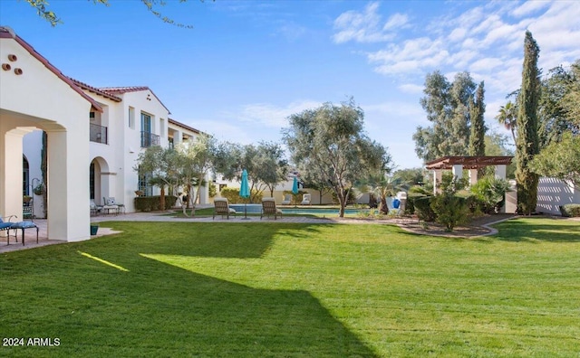 view of home's community featuring a pergola and a yard