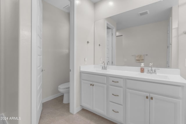 bathroom with vanity, toilet, and tile patterned flooring