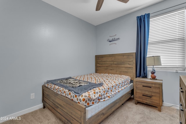 bedroom with light colored carpet and ceiling fan