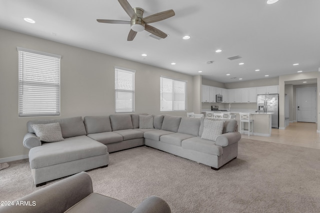 living room with light carpet and ceiling fan