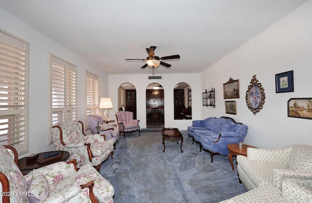 7537 W Bluefield Ave, Glendale, AZ 85308 - carpeted living area featuring arched walkways and a ceiling fan