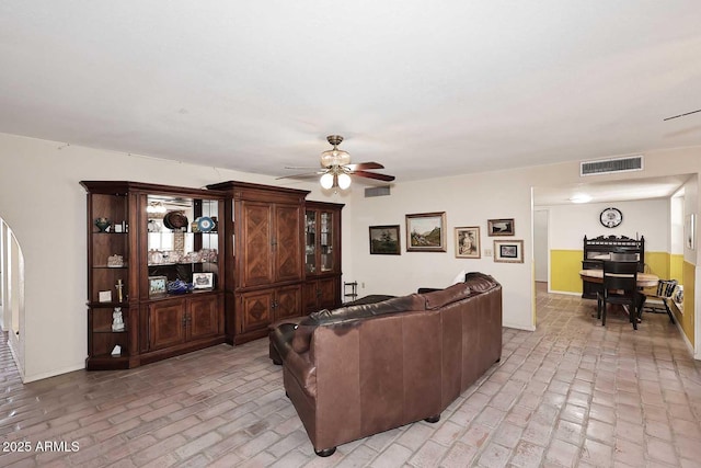 7537 W Bluefield Ave, Glendale, AZ 85308 - living area with brick flooring, ceiling fan, and baseboards