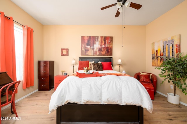 bedroom with ceiling fan and light wood-type flooring