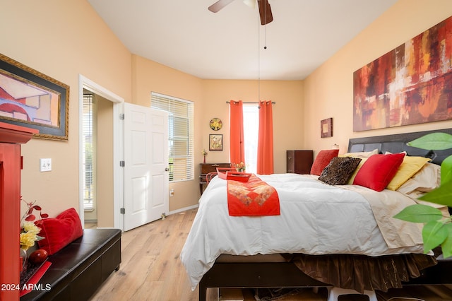 bedroom featuring multiple windows, ceiling fan, and light wood-type flooring