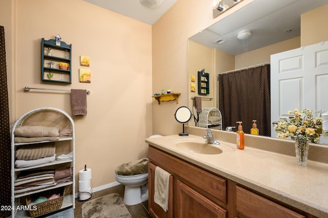 bathroom featuring vanity and toilet