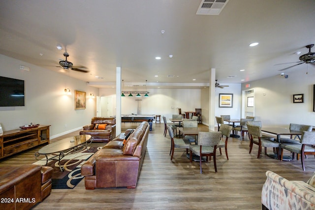 living room featuring hardwood / wood-style floors, ceiling fan, and pool table