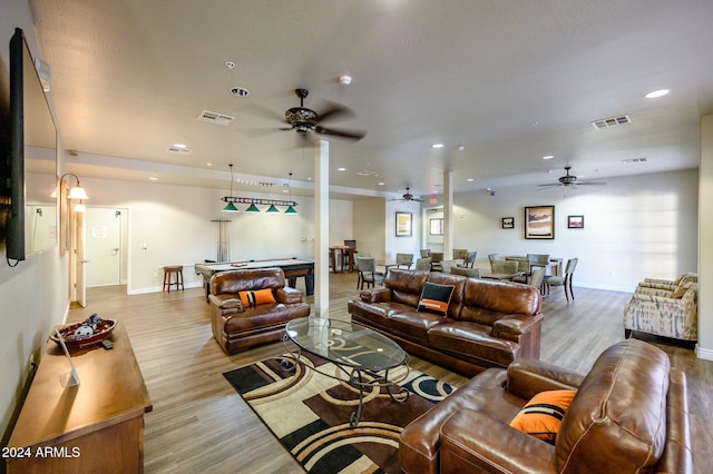 living room featuring light wood-type flooring and ceiling fan