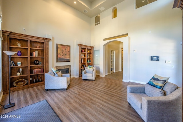 living room featuring a high ceiling and hardwood / wood-style floors