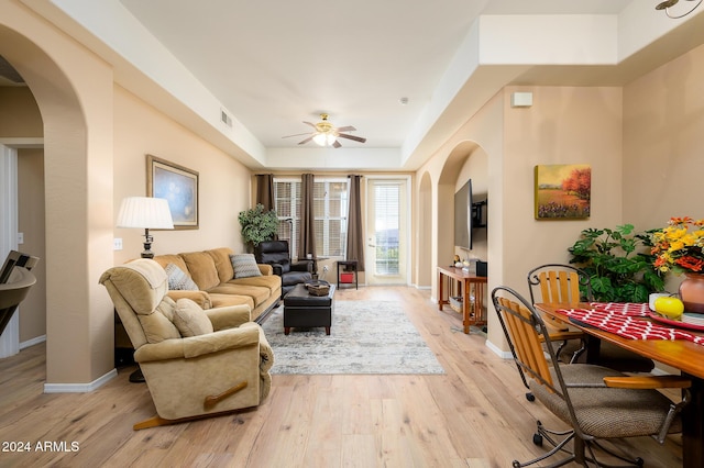 living room with light hardwood / wood-style flooring and ceiling fan