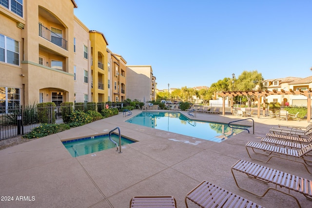 view of pool featuring a pergola, a community hot tub, and a patio