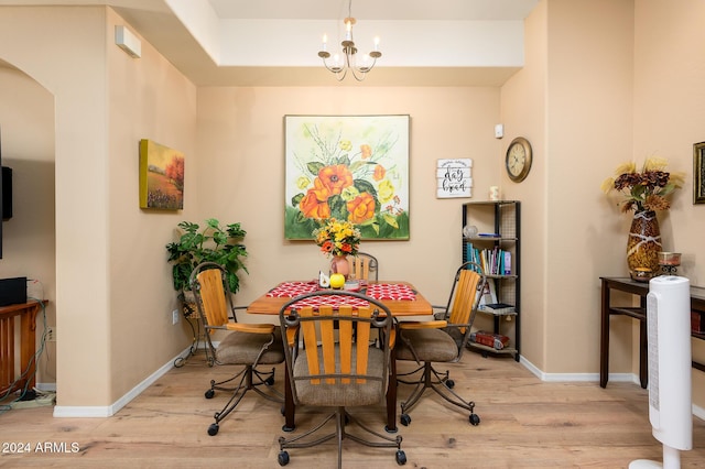 dining area with a chandelier and light hardwood / wood-style floors