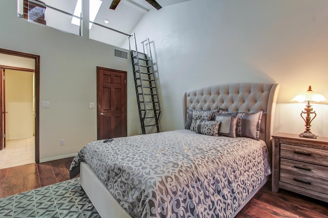 bedroom featuring vaulted ceiling with beams and dark hardwood / wood-style flooring