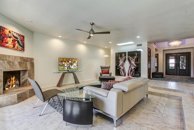 living room with ceiling fan and a fireplace