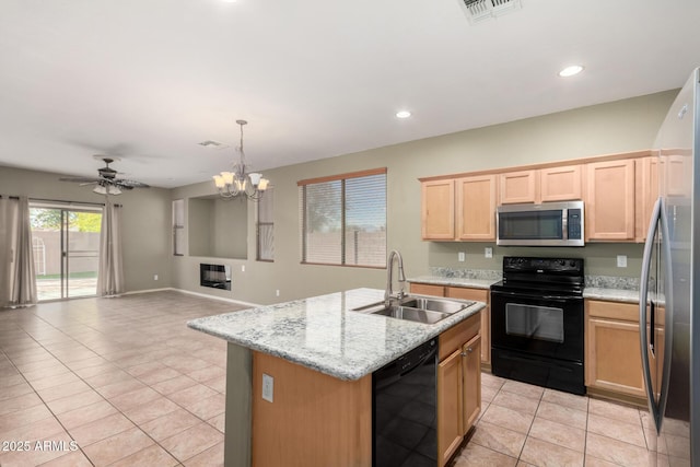 kitchen featuring sink, hanging light fixtures, light brown cabinets, a kitchen island with sink, and black appliances