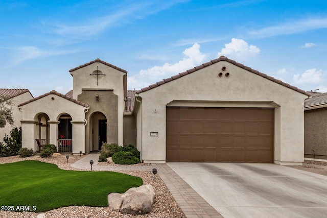 mediterranean / spanish-style home featuring a garage and a front lawn