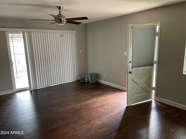 spare room with ceiling fan and dark hardwood / wood-style flooring