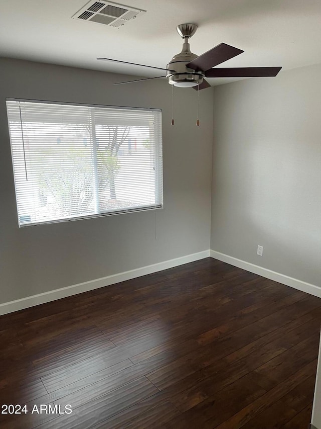 spare room featuring ceiling fan and dark hardwood / wood-style flooring