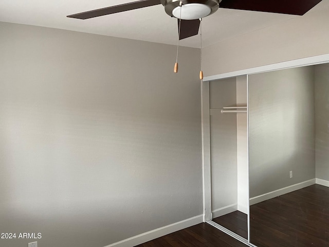 unfurnished bedroom with ceiling fan, dark hardwood / wood-style floors, and a closet