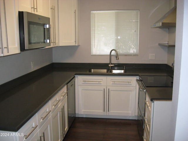 kitchen featuring electric range oven, white dishwasher, sink, dark hardwood / wood-style floors, and white cabinetry