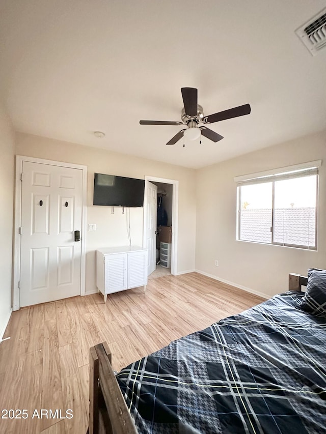 bedroom featuring visible vents, baseboards, ceiling fan, and light wood-type flooring