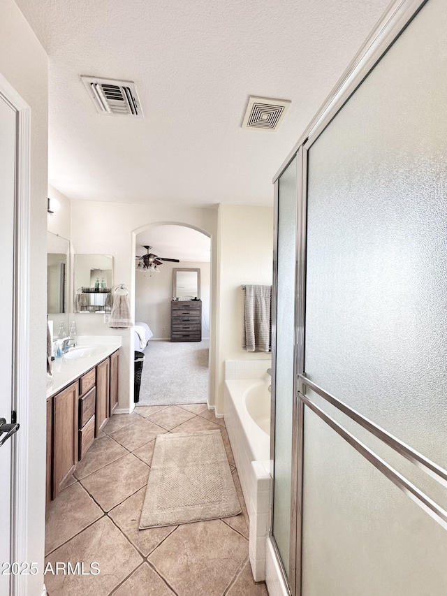 full bath with visible vents, ensuite bathroom, a ceiling fan, and tile patterned flooring