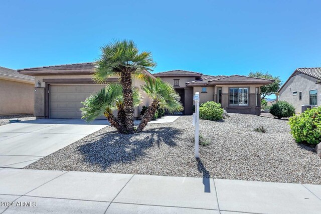 17041 W Artesia Dr, Surprise, AZ 85387 - view of front of property with an attached garage, stucco siding, a tiled roof, and concrete driveway