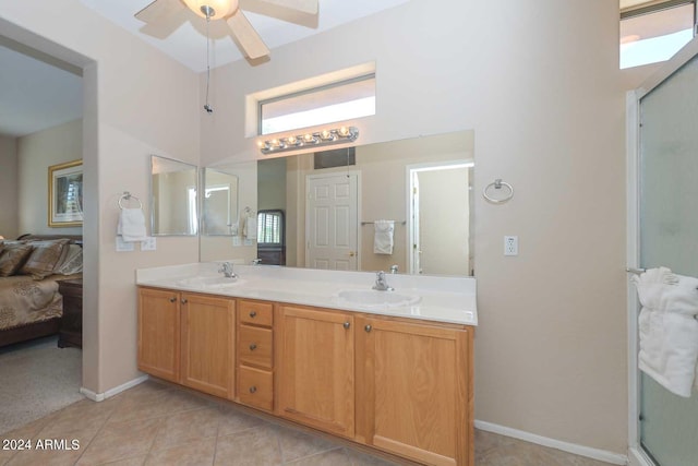 bathroom with vanity, walk in shower, ceiling fan, and tile patterned flooring