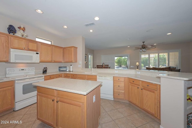 kitchen featuring a center island, kitchen peninsula, white appliances, and light tile patterned flooring