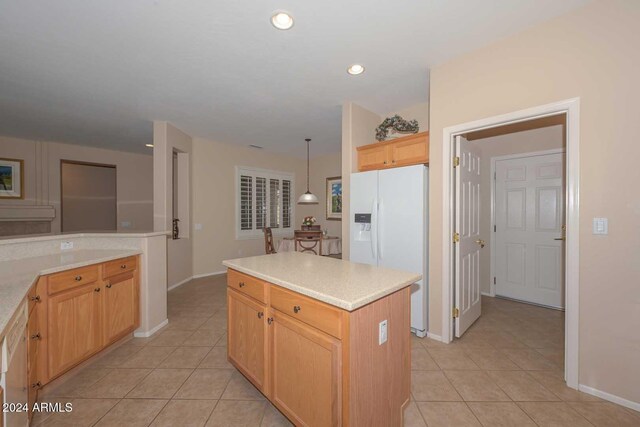 17041 W Artesia Dr, Surprise, AZ 85387 - kitchen featuring light countertops, baseboards, light tile patterned floors, and white fridge with ice dispenser