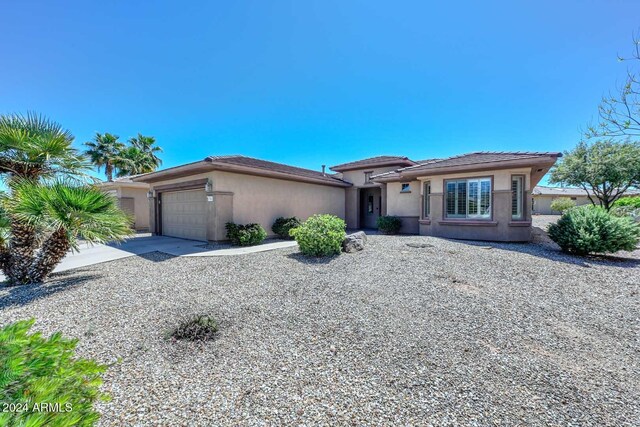 17041 W Artesia Dr, Surprise, AZ 85387 - prairie-style house with a tiled roof, an attached garage, driveway, and stucco siding