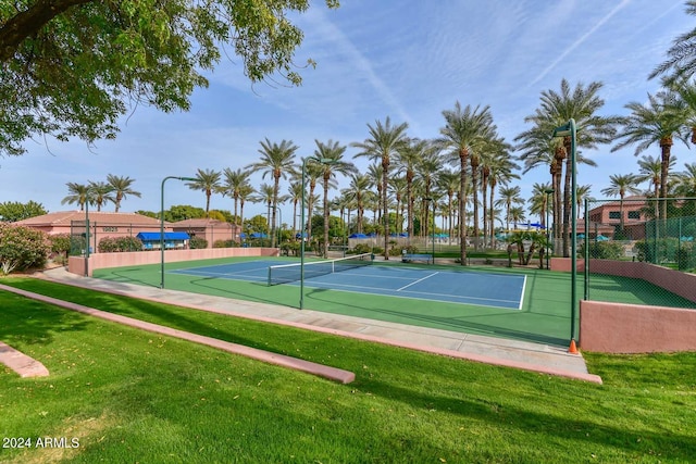 view of sport court featuring a lawn