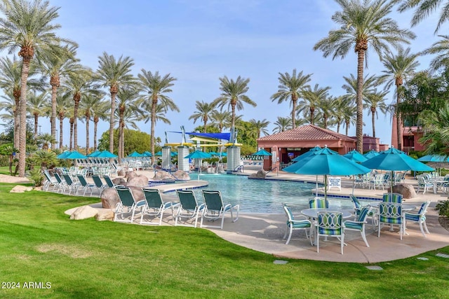 view of swimming pool with a patio and a lawn