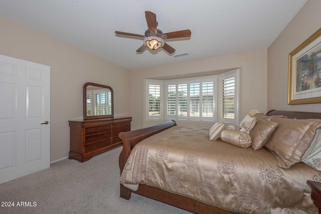 bedroom with light carpet and ceiling fan