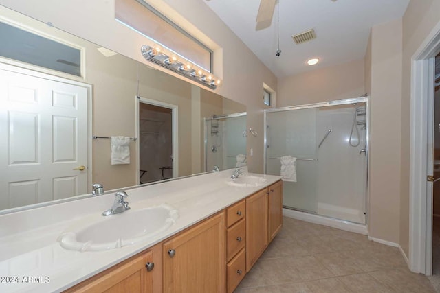 bathroom featuring vanity, ceiling fan, a shower with shower door, and tile patterned flooring