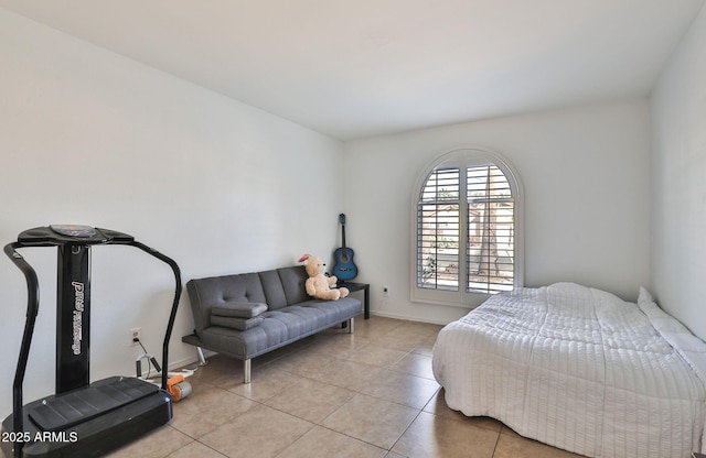 bedroom featuring light tile patterned flooring and baseboards