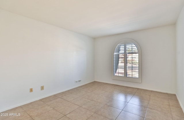 unfurnished room with baseboards