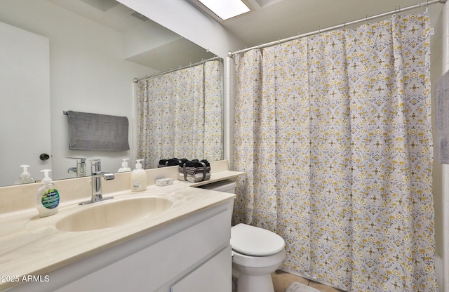 bathroom featuring curtained shower, vanity, and toilet