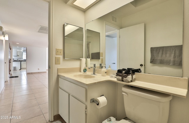 bathroom featuring visible vents, vanity, toilet, and tile patterned floors