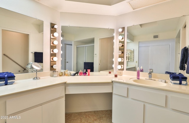 full bath featuring tile patterned flooring, visible vents, a shower stall, and vanity